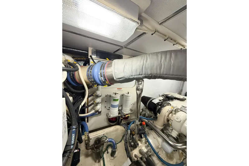 Slide: The Image of Interior of 2007 Nordic Tug 54 with TV, wooden cabinetry, and bathroom. - 35