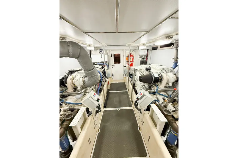 Slide: The Image of Engine room of a 2007 Nordic Tug 54, featuring dual engines and control panels. - 52