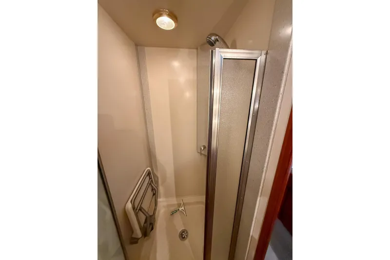 Slide: The Image of Shower area in 2007 Nordic Tug 54 yacht with glass door and grab bar. - 55