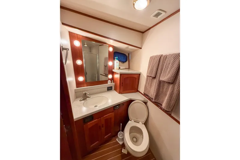 Slide: The Image of Luxurious bathroom in 2007 Nordic Tug 54 yacht with wood accents and modern fixtures. - 57