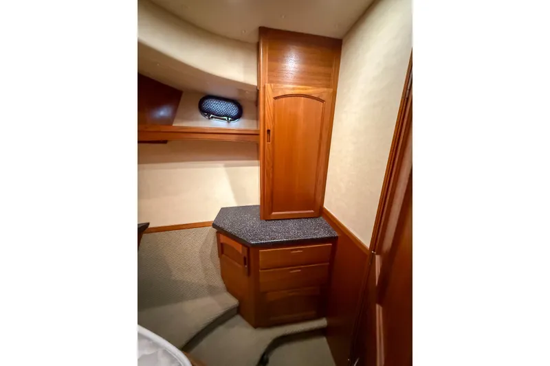 Slide: The Image of Interior of 2007 Nordic Tug 54, featuring wooden cabinetry and carpeted flooring. - 58
