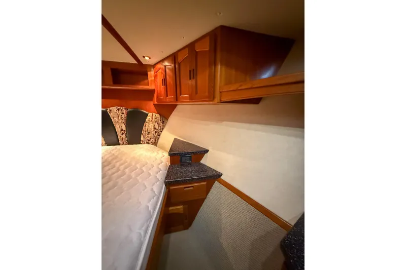 Slide: The Image of Cozy cabin interior of 2007 Nordic Tug 54 with wood cabinetry and comfortable bedding. - 59
