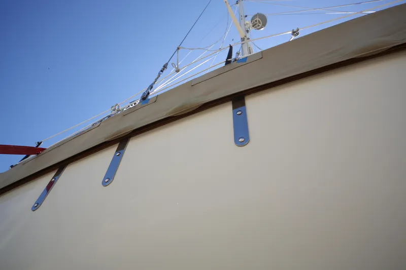 Slide: The Image of 1979 Westsail 32 Shipmaster sailboat with rigging against a clear blue sky. - 11