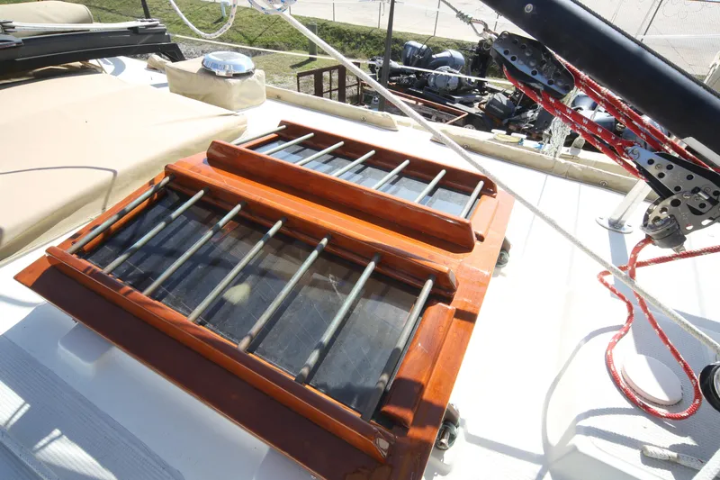 Slide: The Image of 1979 Westsail 32 Shipmaster deck with wooden hatch and rigging details. - 14