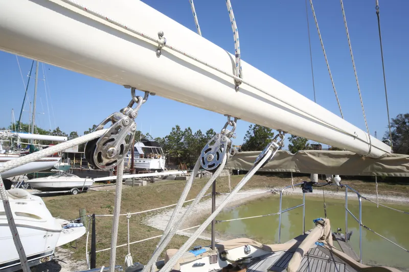 Slide: The Image of 1979 Westsail 32 Shipmaster sailboat rigging and mast detail in a boatyard setting. - 22