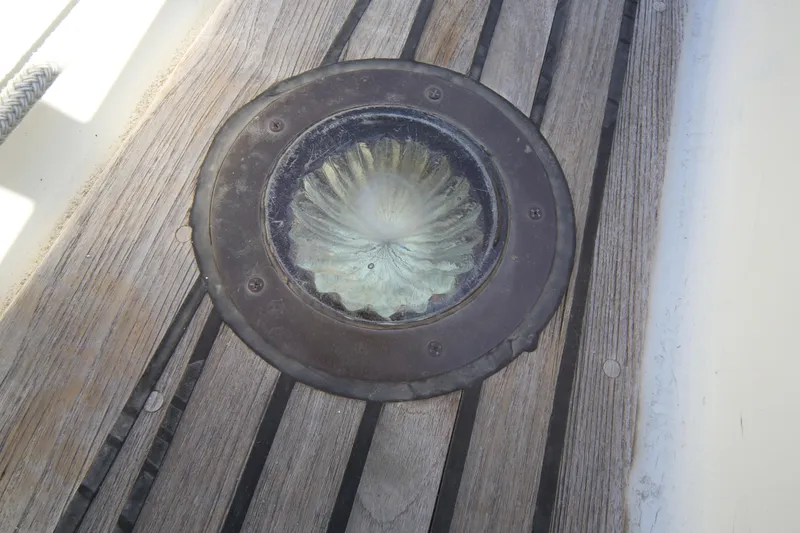 Slide: The Image of Deck prism on 1979 Westsail 32 Shipmaster, set in wooden deck planks. - 25