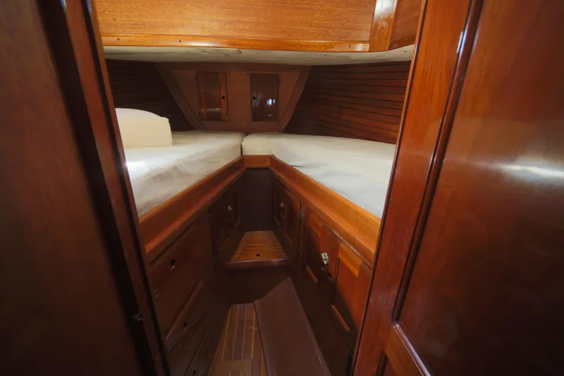 Slide: The Image of 1979 Westsail 32 Shipmaster cabin interior with wooden finish and twin beds. - 31
