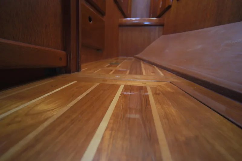 Slide: The Image of Polished wooden interior flooring of 1979 Westsail 32 Shipmaster yacht. - 33