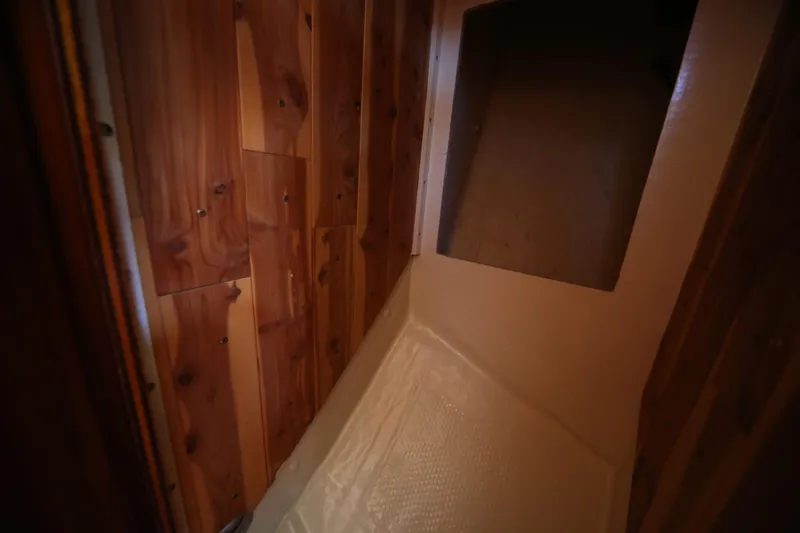 Slide: The Image of Interior of 1979 Westsail 32 Shipmaster with wooden paneling and storage space. - 37