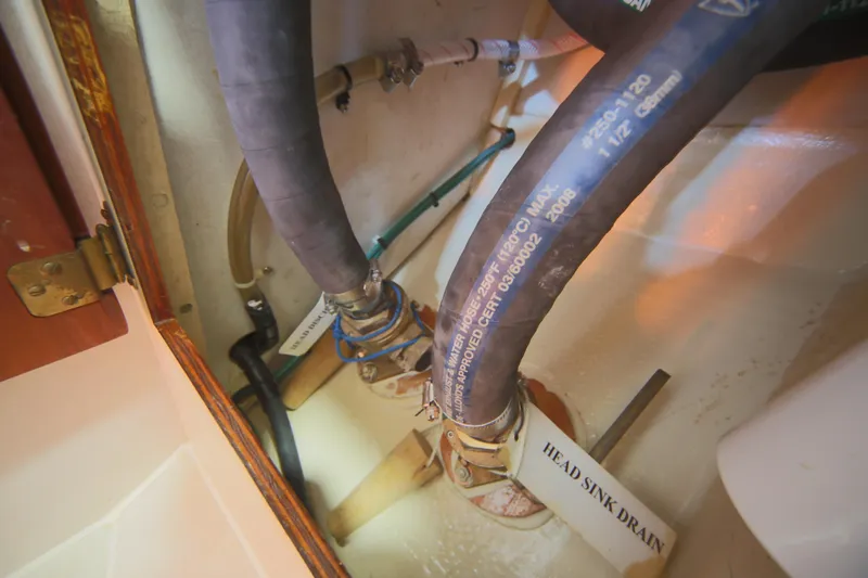 Slide: The Image of Plumbing system of 1979 Westsail 32 Shipmaster, featuring labeled hoses and fittings. - 38