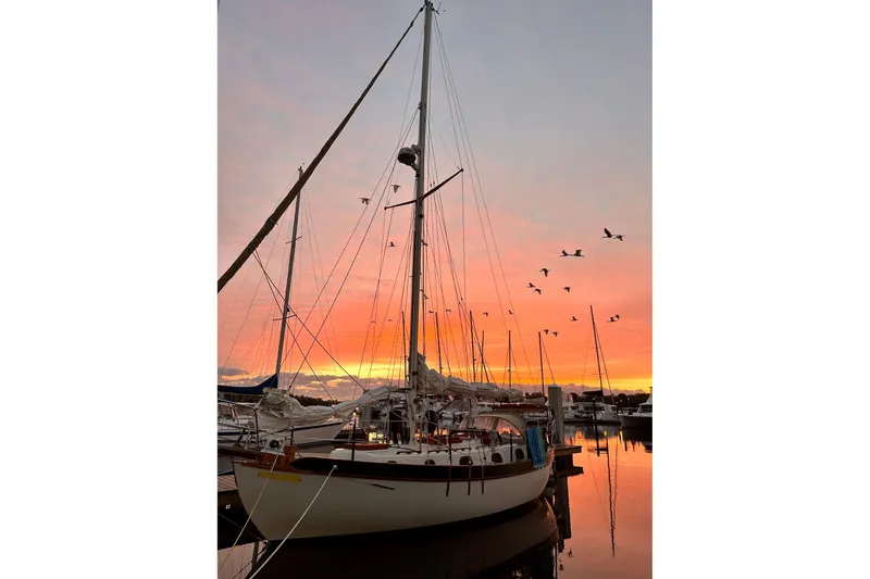 Slide: The Image of Westsail 32 Shipmaster 1979 sailboat at sunset with birds flying overhead. - 4