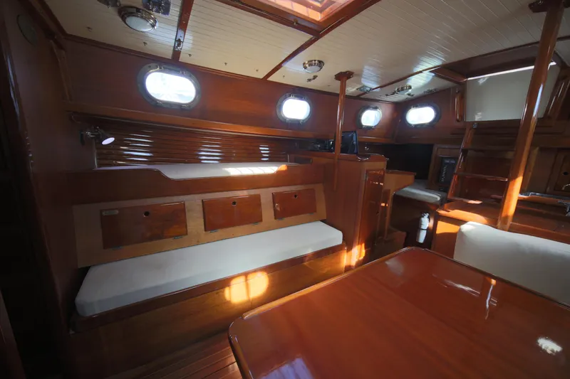 Slide: The Image of 1979 Westsail 32 Shipmaster interior with wooden finish and seating area. - 42