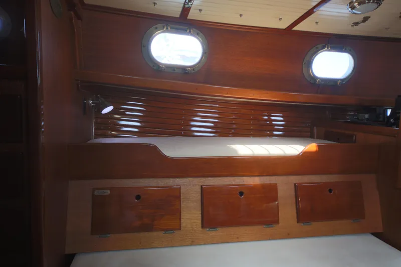 Slide: The Image of Interior of 1979 Westsail 32 Shipmaster with wooden cabinetry and portholes. - 43