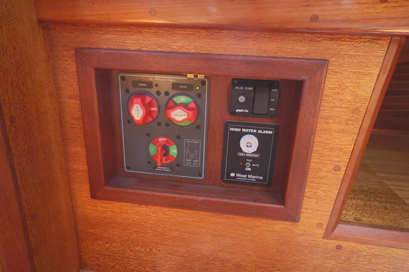 Slide: The Image of Control panel on 1979 Westsail 32 Shipmaster, featuring switches and high water alarm. - 45