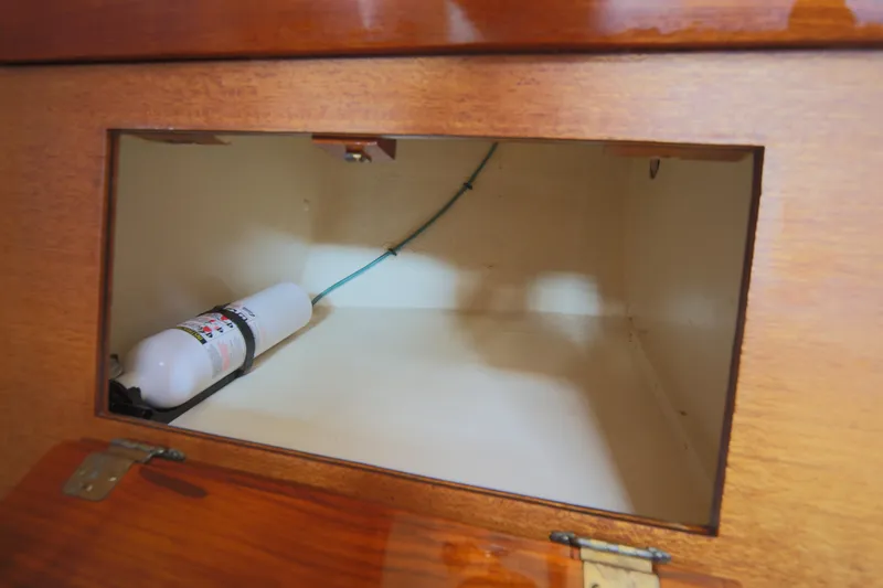 Slide: The Image of Interior storage compartment of 1979 Westsail 32 Shipmaster with fire extinguisher. - 47