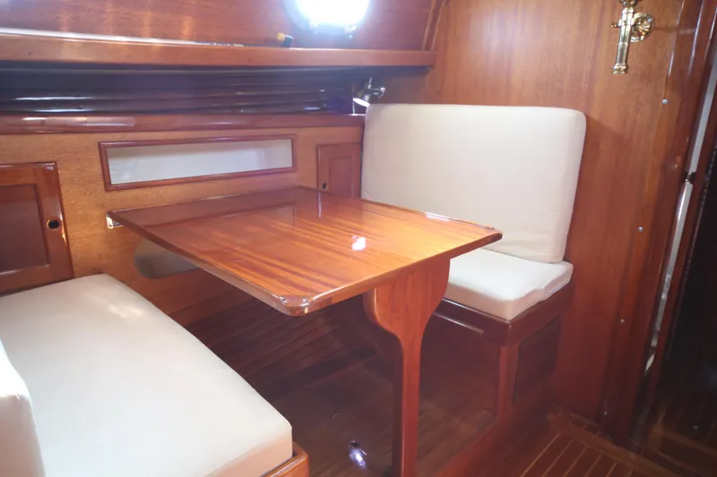 Slide: The Image of 1979 Westsail 32 Shipmaster interior with wooden table and cushioned seating. - 49