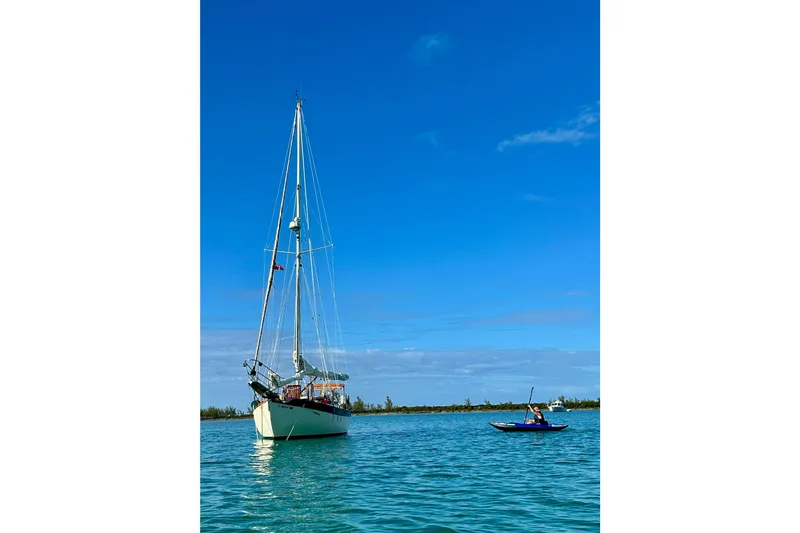 Slide: The Image of Sailboat Westsail 32 Shipmaster 1979 on calm water with clear blue sky. - 5