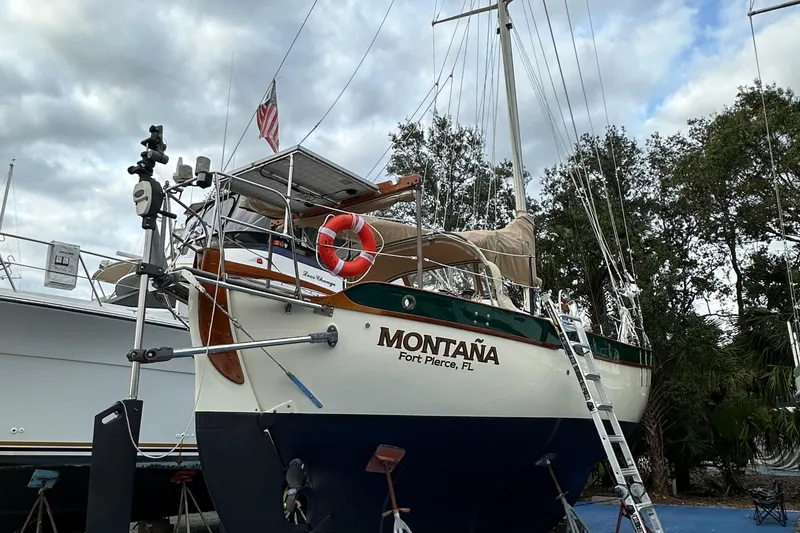 Slide: The Image of 1979 Westsail 32 Shipmaster sailboat "Montaña" docked, Fort Pierce, FL, with overcast sky. - 7