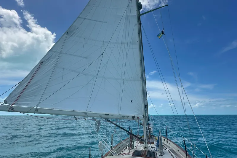 Slide: The Image of Sailing on a 1979 Westsail 32 Shipmaster under clear blue skies. - 70