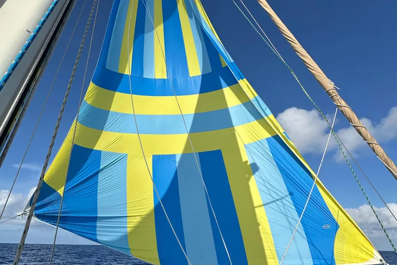 Slide: The Image of Colorful sail of 1979 Westsail 32 Shipmaster against clear blue sky. - 75