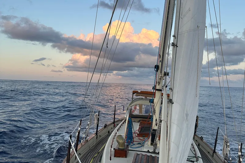 Slide: The Image of Sailing on a 1979 Westsail 32 Shipmaster under a vibrant sunset sky. - 77