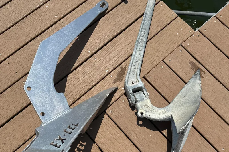 Slide: The Image of Two metal boat anchors on a wooden dock, suitable for a 1979 Westsail 32 Shipmaster. - 83