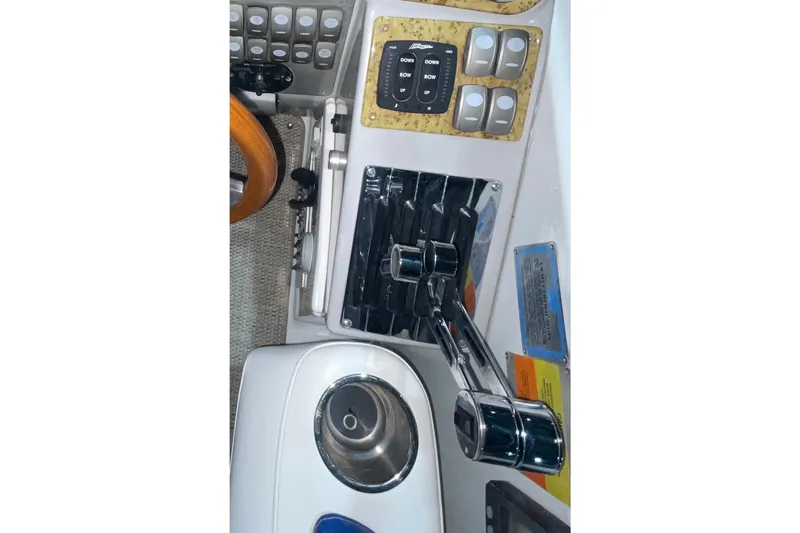 Slide: The Image of 2008 Formula 34 Performance Cruiser helm controls with switches and throttle levers. - 10