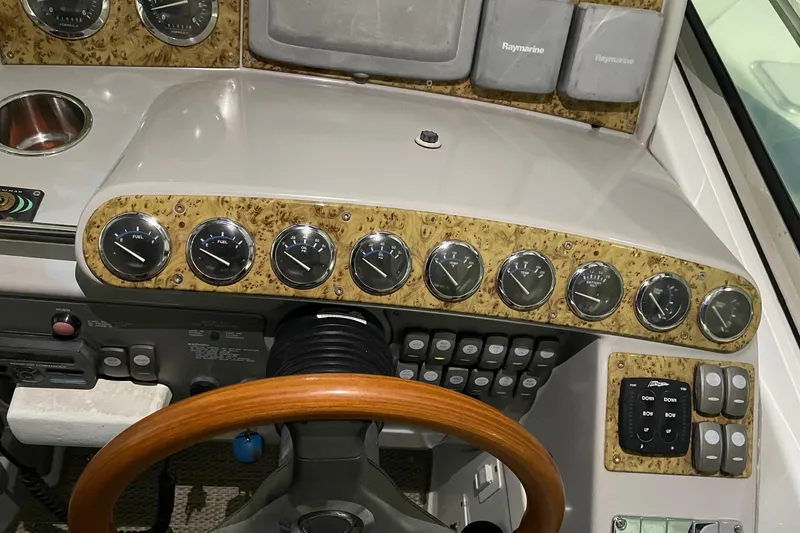 Slide: The Image of 2008 Formula 34 Performance Cruiser dashboard with gauges and wood-trimmed steering wheel. - 41