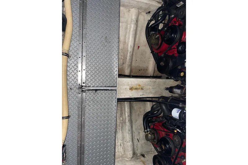 Slide: The Image of Engine compartment of 2008 Formula 34 Performance Cruiser with visible components and metal flooring. - 42