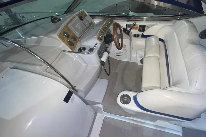 Slide: The Image of 2008 Formula 34 Performance Cruiser cockpit with white seating and wood-accented dashboard. - 8