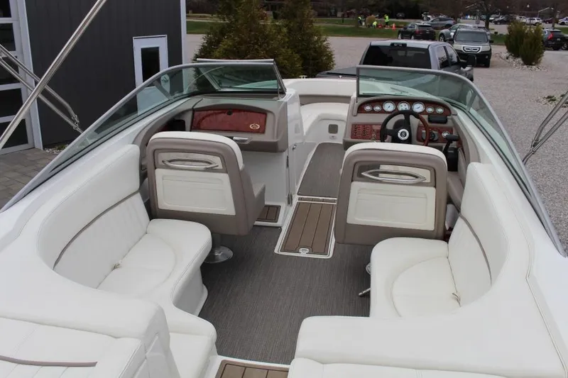 Slide: The Image of 2004 Cobalt 262 boat interior with white seating and wooden dashboard. - 4