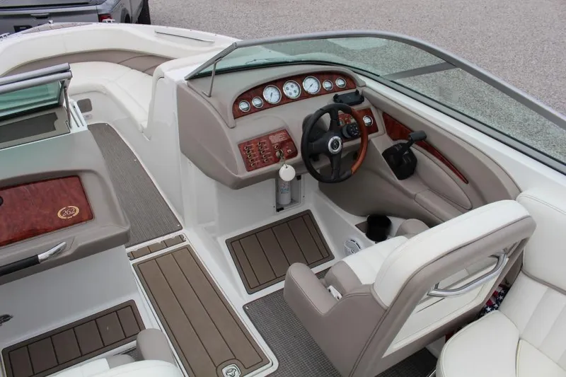 Slide: The Image of 2004 Cobalt 262 boat interior with steering wheel, dashboard, and seating. - 5