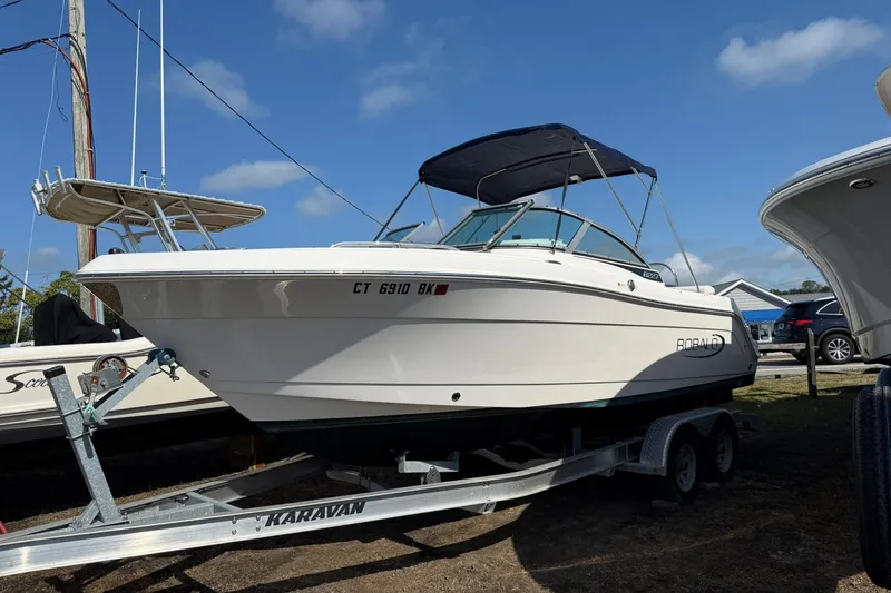 The Image of 2019 Robalo R227 Dual Console boat on trailer under blue sky. - 0