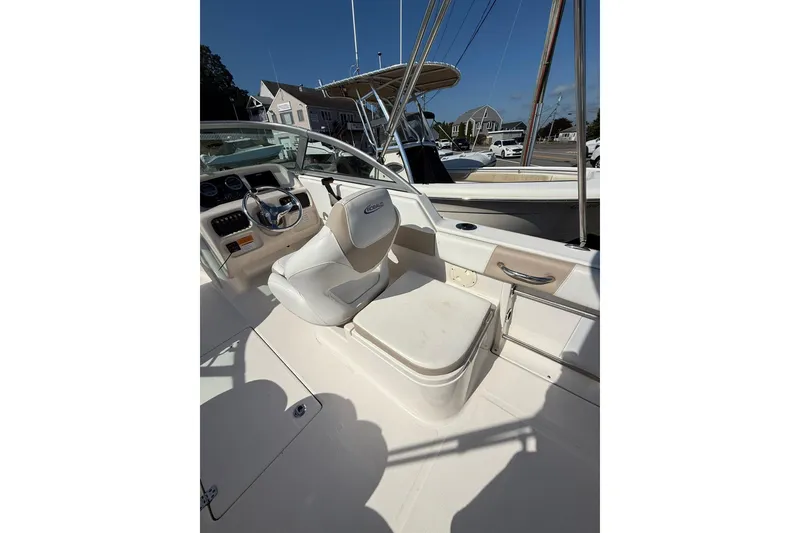 Slide: The Image of 2019 Robalo R227 Dual Console boat interior with steering wheel and seating. - 14