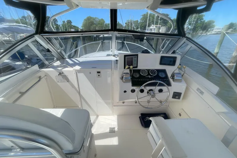 Slide: The Image of 2002 Albemarle 280 Express Fisherman boat cockpit with steering wheel and navigation instruments. - 3