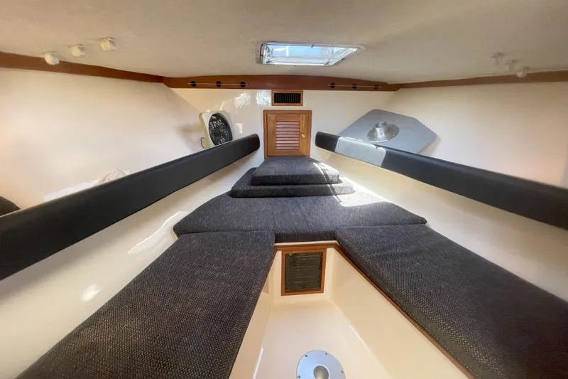 Slide: The Image of Interior cabin of 2002 Albemarle 280 Express Fisherman with cushioned seating and overhead hatch. - 4