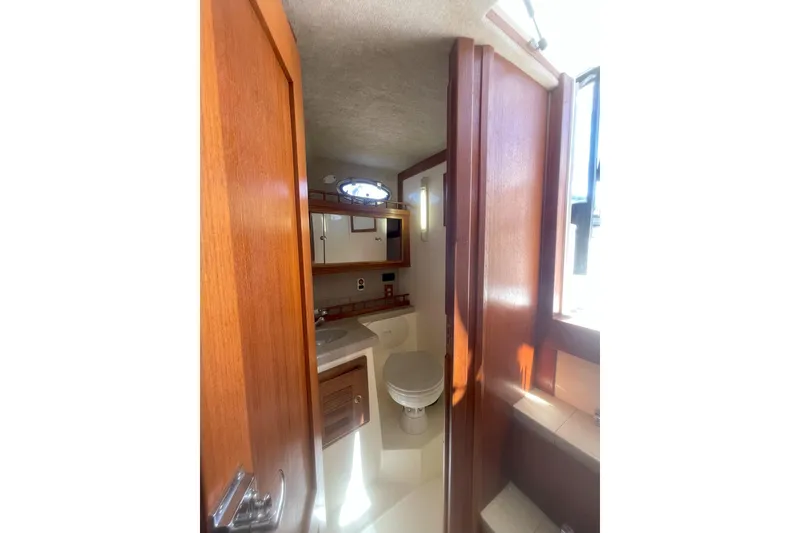 Slide: The Image of Interior of 2002 Albemarle 280 Express Fisherman boat bathroom with wooden cabinetry. - 5