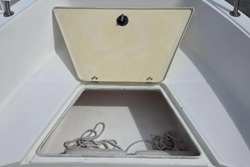 Slide: The Image of Open storage compartment on 2008 Key West Center Console boat with ropes inside. - 6