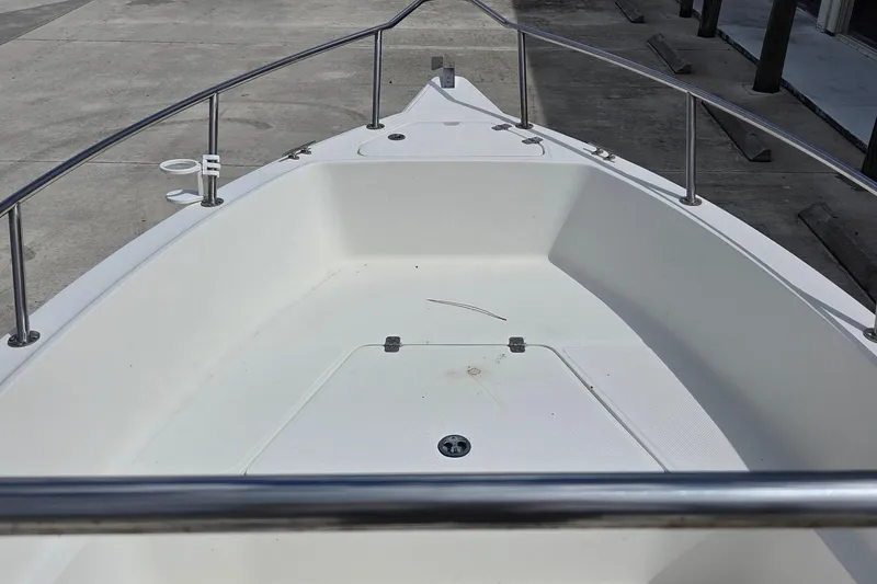 Slide: The Image of Front deck of a 2008 Key West 2020 Center Console boat, featuring stainless steel railings. - 9