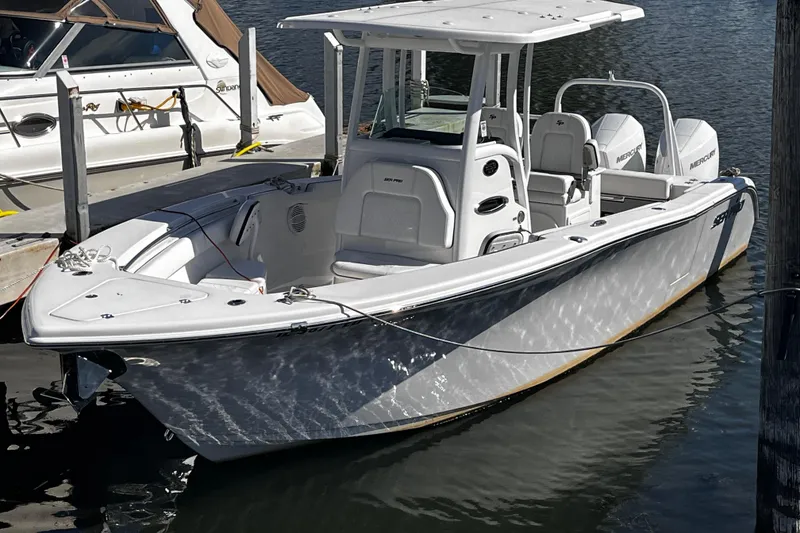 The Image of 2022 Sea Pro 259 Deep V CC boat docked in marina, featuring sleek design and spacious deck. - 0