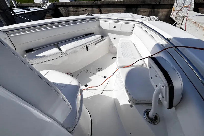 Slide: The Image of 2022 Sea Pro 259 Deep V CC boat interior with white seating and deck. - 11