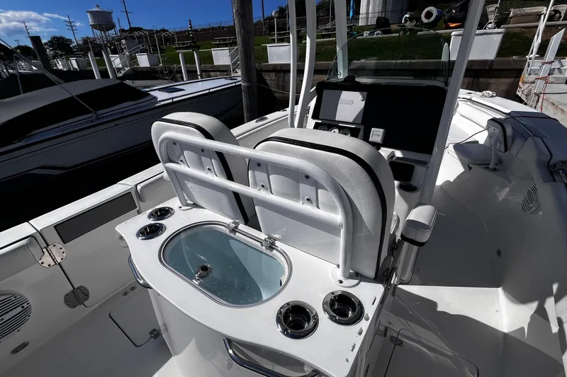 Slide: The Image of 2022 Sea Pro 259 Deep V CC boat interior with seating and control panel. - 2