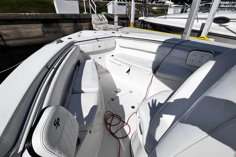 Slide: The Image of 2022 Sea Pro 259 Deep V CC boat interior with white seating and deck details. - 4