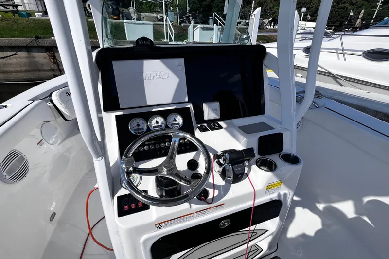 Slide: The Image of 2022 Sea Pro 259 Deep V CC boat console with steering wheel and navigation display. - 5