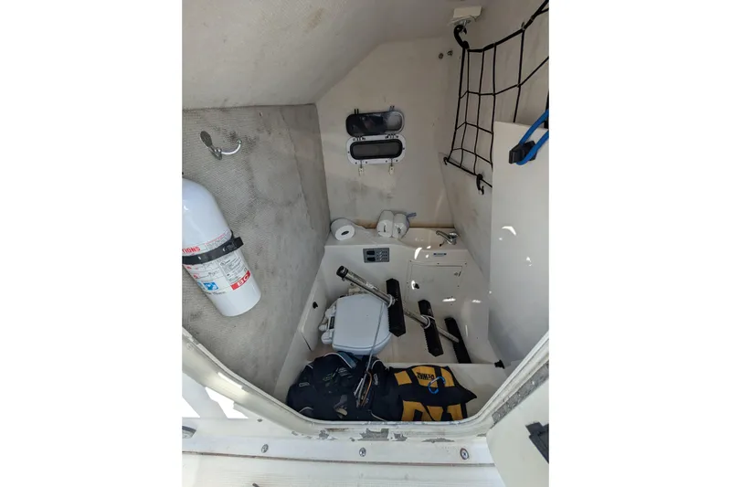 Slide: The Image of 2004 Pursuit 2870 Center Console interior with safety equipment and storage. - 10
