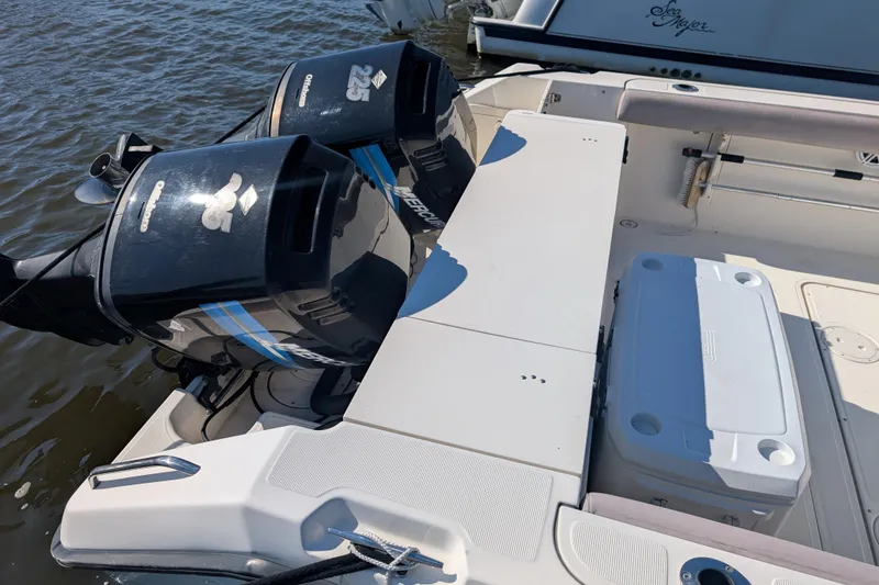 Slide: The Image of 2004 Pursuit 2870 Center Console boat with twin outboard engines on water. - 12