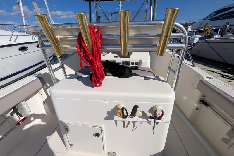 Slide: The Image of 2004 Pursuit 2870 Center Console boat interior with fishing rod holders and equipment. - 6