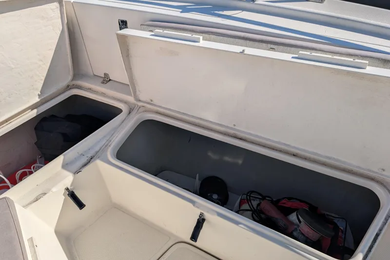 Slide: The Image of Open storage compartments on a 2004 Pursuit 2870 Center Console boat. - 8