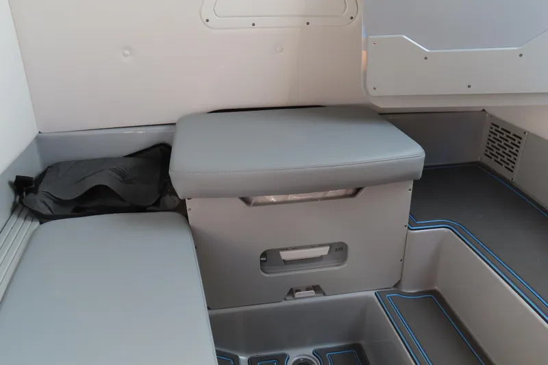 Slide: The Image of 2024 Sunsation 32CCX interior seating area with gray cushions and storage compartments. - 12