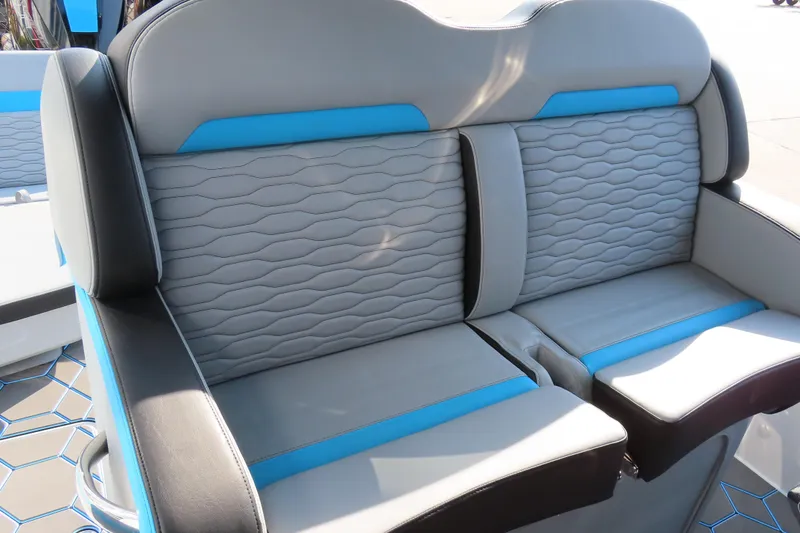 Slide: The Image of 2024 Sunsation 32CCX boat seating with gray and blue upholstery, modern design. - 16